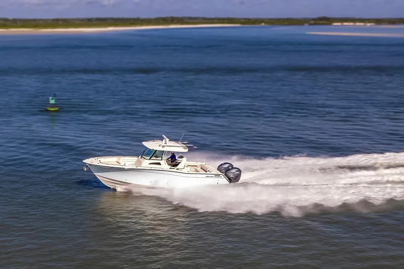  Yacht Photos Pics 2022 Grady-White Canyon 336 boat cruising on open water, creating a wake.