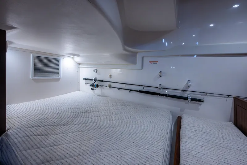  Yacht Photos Pics 2022 Pursuit OS 355 Offshore cabin interior with fishing rod storage.