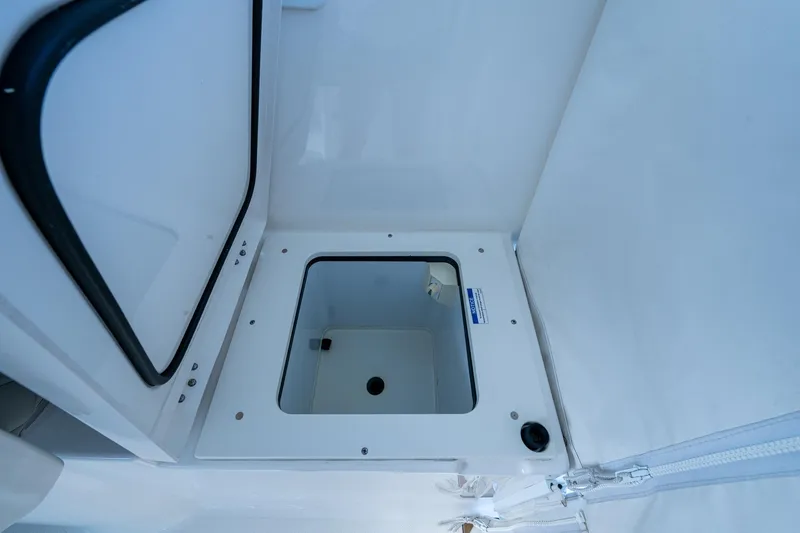  Yacht Photos Pics 2022 Pursuit OS 355 Offshore storage compartment with open lid, showcasing interior space.
