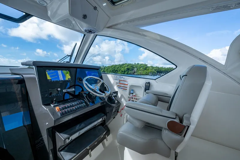  Yacht Photos Pics 2022 Pursuit OS 355 Offshore helm with modern navigation system and comfortable seating.