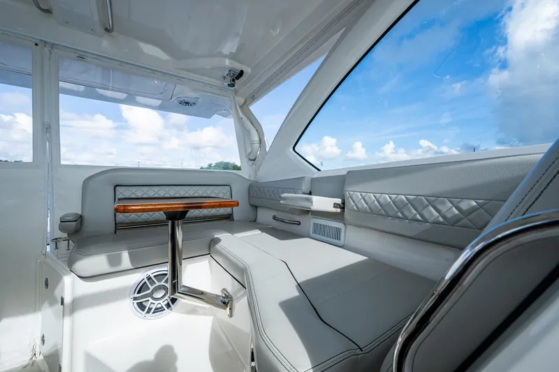  Yacht Photos Pics 2022 Pursuit OS 355 Offshore interior with luxurious seating and elegant design.