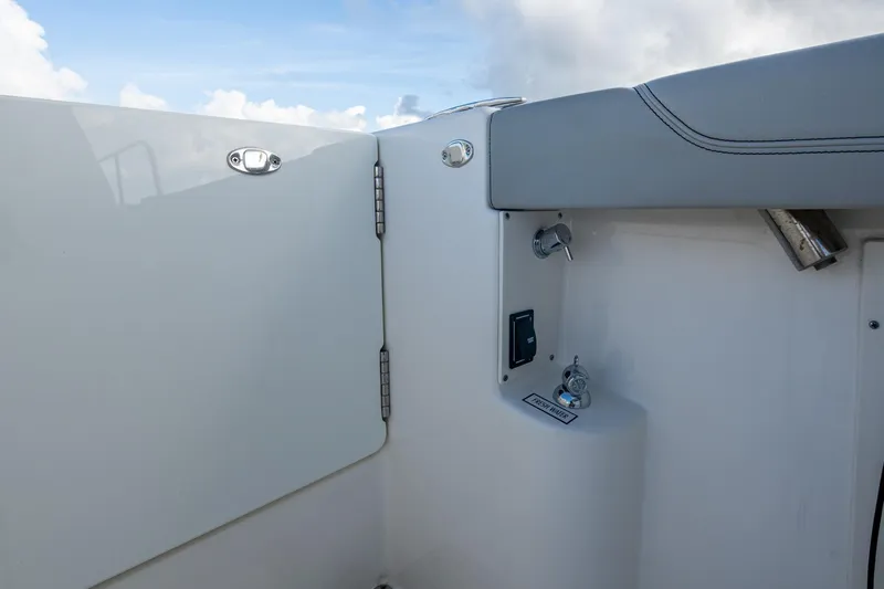  Yacht Photos Pics 2022 Pursuit OS 355 Offshore boat interior detail with fresh water access and sleek design.
