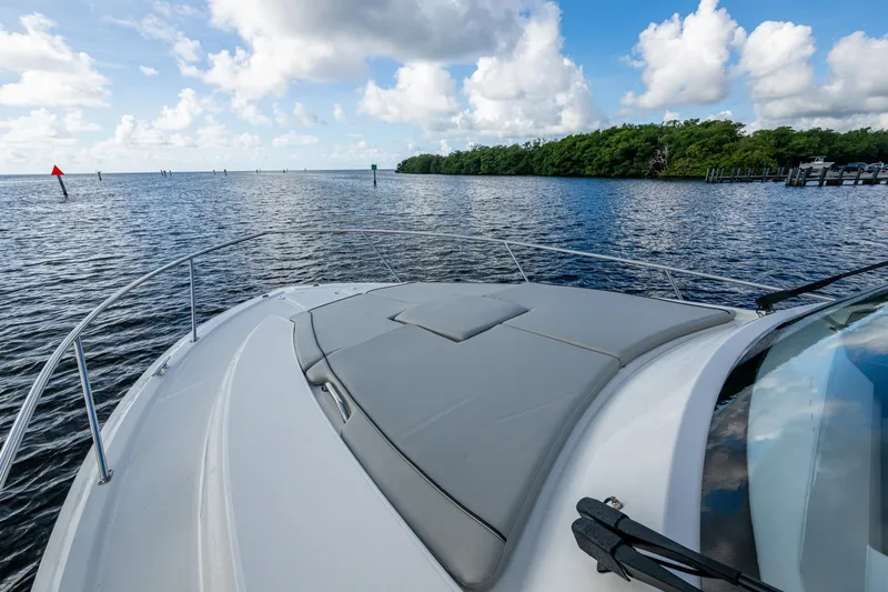  Yacht Photos Pics 2022 Pursuit OS 355 Offshore boat cruising on a calm, scenic waterway.
