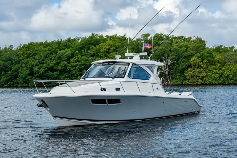  Yacht Photos Pics 2022 Pursuit OS 355 Offshore boat cruising on a scenic waterway.