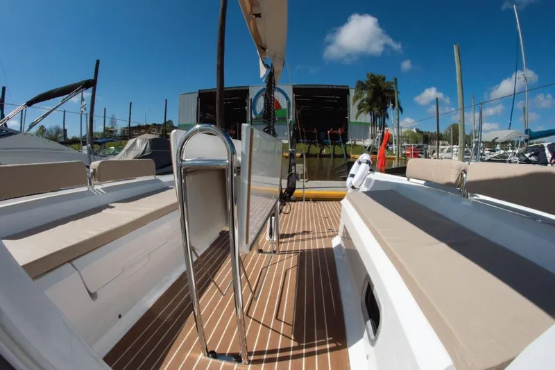Z28 Yacht Photos Pics 2025 Zonda Yachts Z28 deck view with seating, docked under clear blue sky.