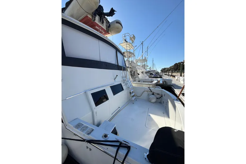 La Vie Dansante Yacht Photos Pics 1991 Californian 55 Cockpit Motor Yacht docked, showcasing spacious deck and sleek design.
