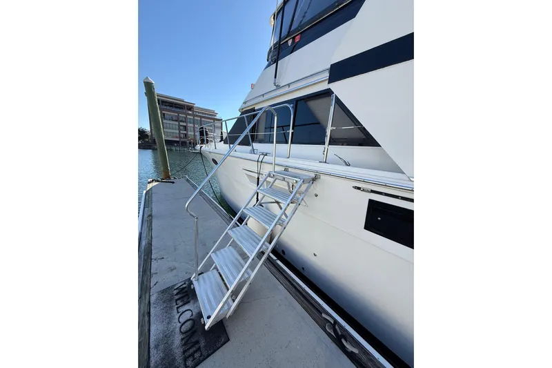 La Vie Dansante Yacht Photos Pics 1991 Californian 55 Cockpit Motor Yacht docked with boarding ladder and welcome mat.