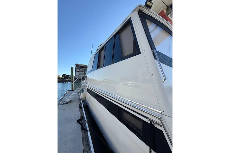 La Vie Dansante Yacht Photos Pics 1991 Californian 55 Cockpit Motor Yacht docked, showcasing sleek design and windows.