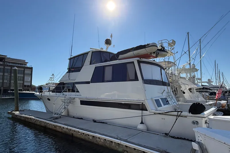 La Vie Dansante Yacht Photos Pics 1991 Californian 55 Cockpit Motor Yacht docked under clear blue sky.