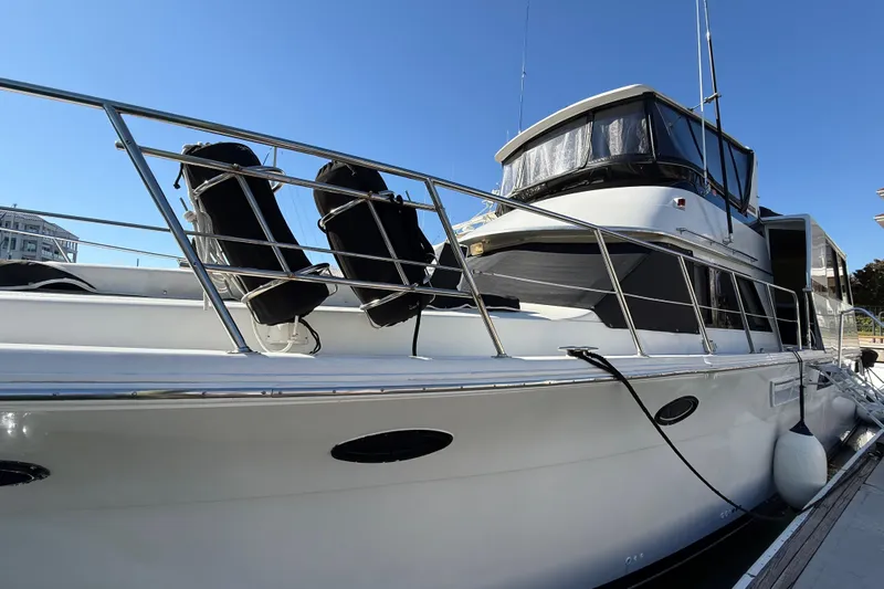 La Vie Dansante Yacht Photos Pics 1991 Californian 55 Cockpit Motor Yacht docked under clear blue sky.