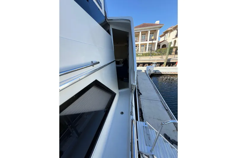 La Vie Dansante Yacht Photos Pics 1991 Californian 55 Cockpit Motor Yacht docked, showing side view and entrance.