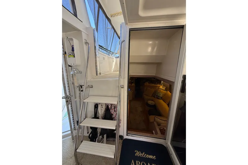 La Vie Dansante Yacht Photos Pics Interior view of 1991 Californian 55 Cockpit Motor Yacht with stairs and cozy seating area.