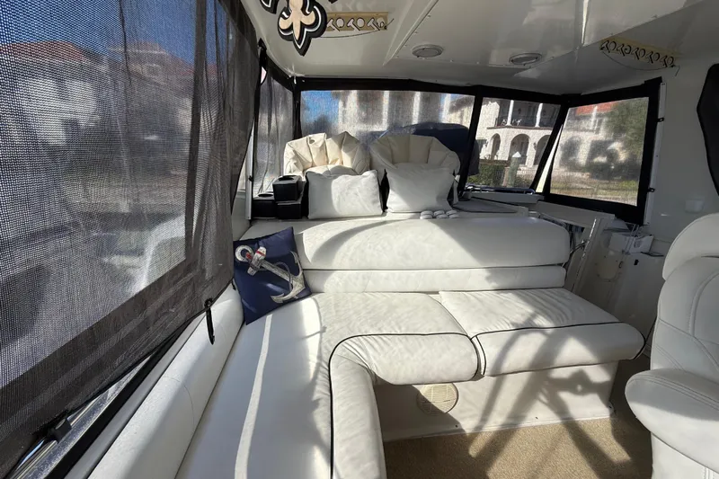 La Vie Dansante Yacht Photos Pics Interior of 1991 Californian 55 Cockpit Motor Yacht with white seating and nautical decor.