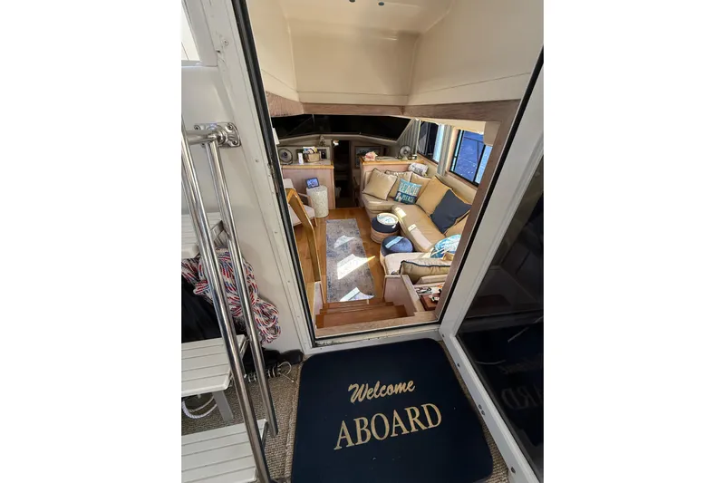 La Vie Dansante Yacht Photos Pics Interior view of 1991 Californian 55 Cockpit Motor Yacht with cozy seating and welcome mat.