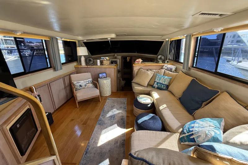 La Vie Dansante Yacht Photos Pics Luxurious interior of a 1991 Californian 55 Cockpit Motor Yacht with cozy seating and nautical decor.