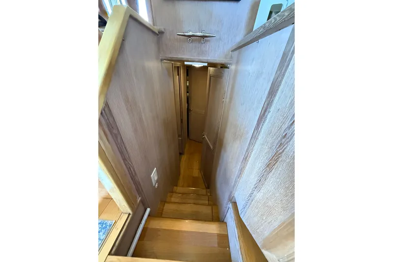 La Vie Dansante Yacht Photos Pics Staircase inside 1991 Californian 55 Cockpit Motor Yacht, featuring wooden steps and walls.