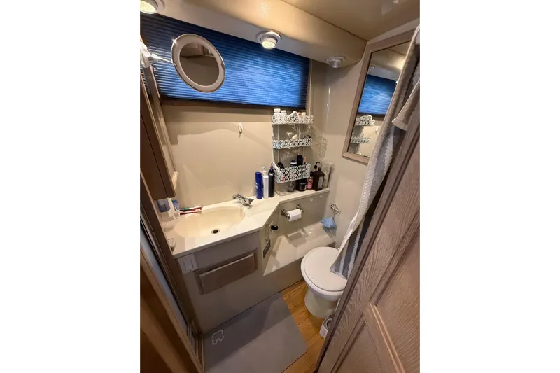 La Vie Dansante Yacht Photos Pics Bathroom interior of 1991 Californian 55 Cockpit Motor Yacht, featuring sink and toilet.