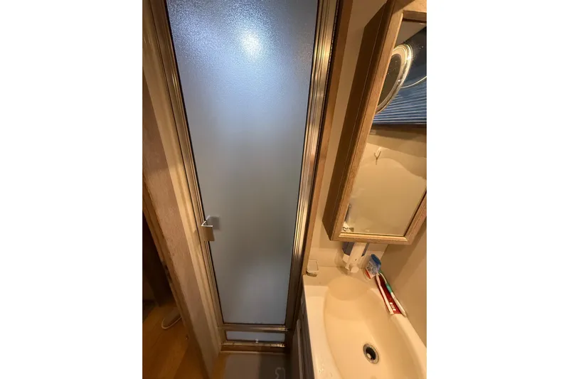 La Vie Dansante Yacht Photos Pics Bathroom interior of 1991 Californian 55 Cockpit Motor Yacht with shower and sink.