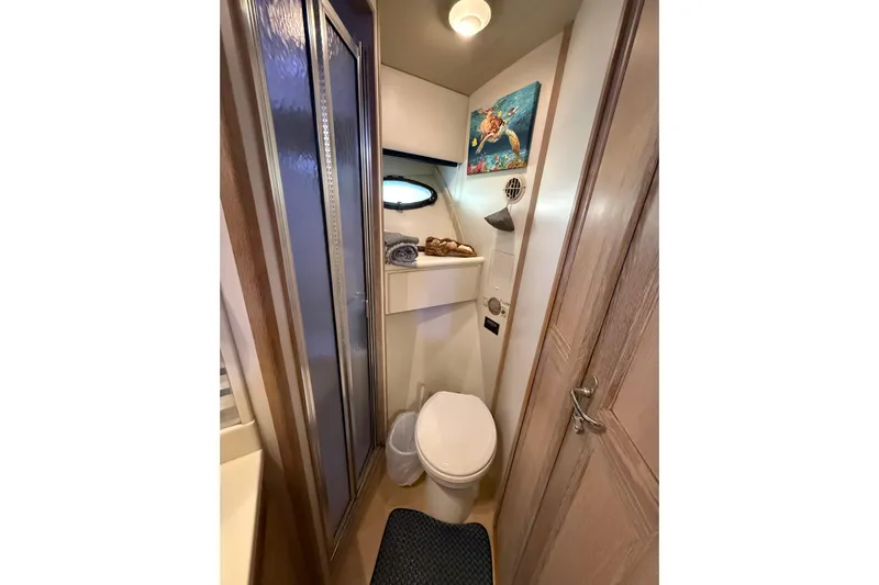 La Vie Dansante Yacht Photos Pics Bathroom interior of 1991 Californian 55 Cockpit Motor Yacht with shower and marine decor.