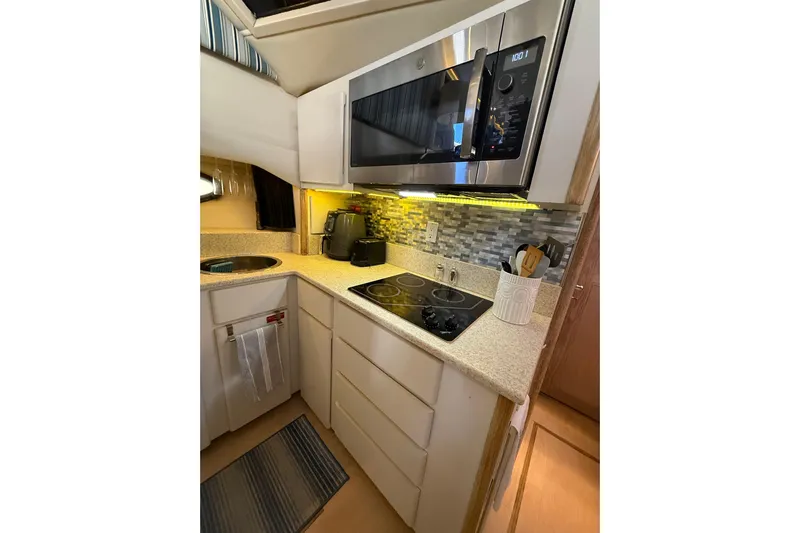 La Vie Dansante Yacht Photos Pics Modern kitchen in 1991 Californian 55 Cockpit Motor Yacht with microwave and stovetop.