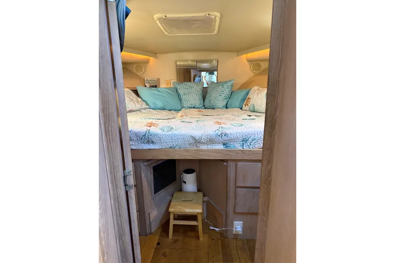 La Vie Dansante Yacht Photos Pics Cozy bedroom interior of 1991 Californian 55 Cockpit Motor Yacht with nautical decor.