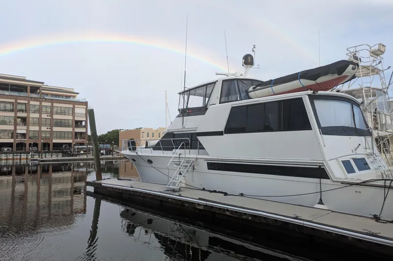 La Vie Dansante Yacht Photos Pics 1991 Californian 55 Cockpit Motor Yacht docked with rainbow in background.