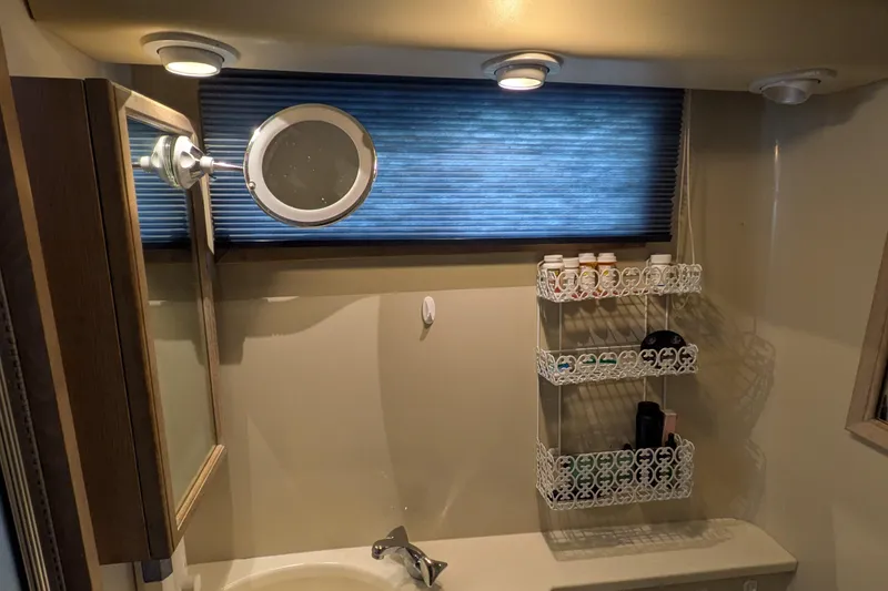 La Vie Dansante Yacht Photos Pics Bathroom interior of 1991 Californian 55 Cockpit Motor Yacht with mirror and shelf.