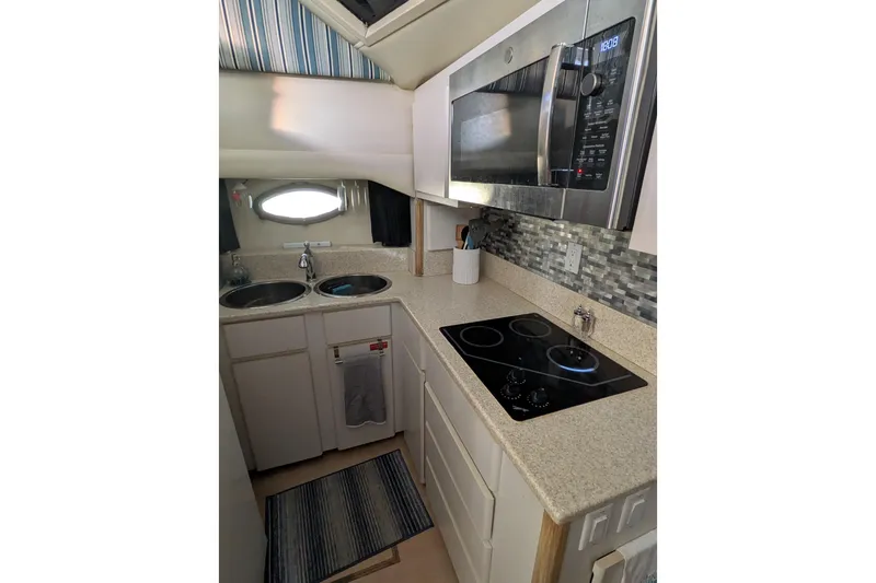 La Vie Dansante Yacht Photos Pics 1991 Californian 55 Cockpit Motor Yacht kitchen with modern appliances and sleek countertops.