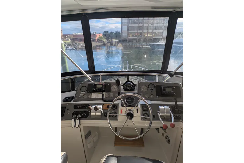 La Vie Dansante Yacht Photos Pics Cockpit view of 1991 Californian 55 Cockpit Motor Yacht with steering wheel and controls.