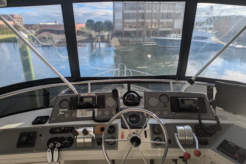 La Vie Dansante Yacht Photos Pics Cockpit view of 1991 Californian 55 Cockpit Motor Yacht with marina backdrop.