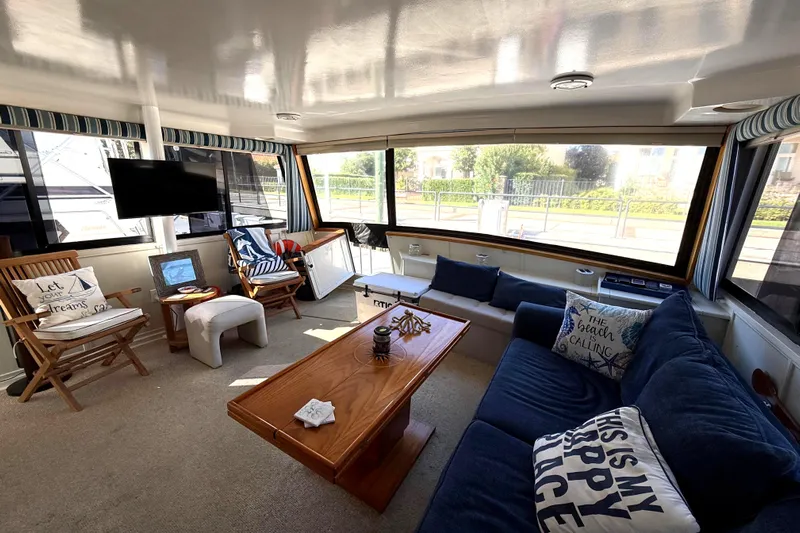 La Vie Dansante Yacht Photos Pics Luxurious interior of 1991 Californian 55 Cockpit Motor Yacht with cozy seating and decor.