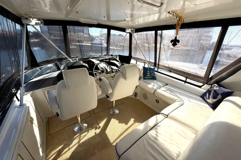 La Vie Dansante Yacht Photos Pics Luxurious 1991 Californian 55 Cockpit Motor Yacht interior with plush seating and helm.