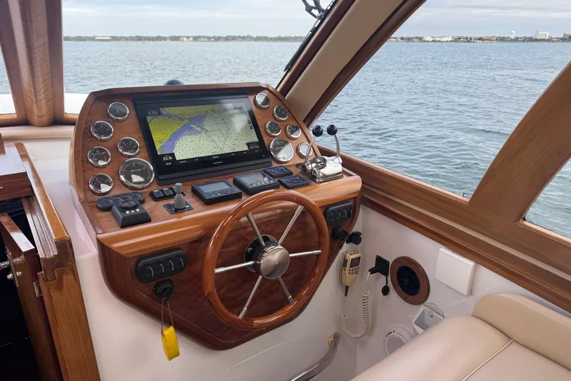 Mango Tango Yacht Photos Pics Helm of 2014 San Juan 41 yacht with navigation system and wooden steering wheel.
