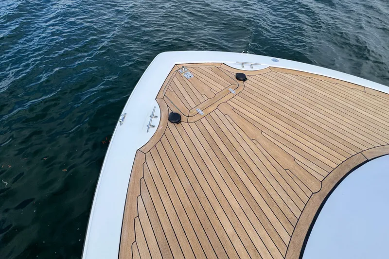 Mango Tango Yacht Photos Pics Bow of 2014 San Juan 41 yacht with teak decking on calm water.