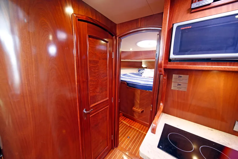 Mango Tango Yacht Photos Pics Luxurious 2014 San Juan 41 yacht interior with wood finish, kitchenette, and cozy sleeping area.
