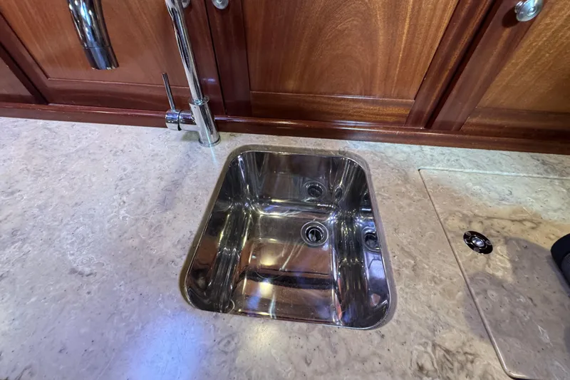 Mango Tango Yacht Photos Pics Stainless steel sink in a 2014 San Juan 41 yacht's elegant wooden interior.