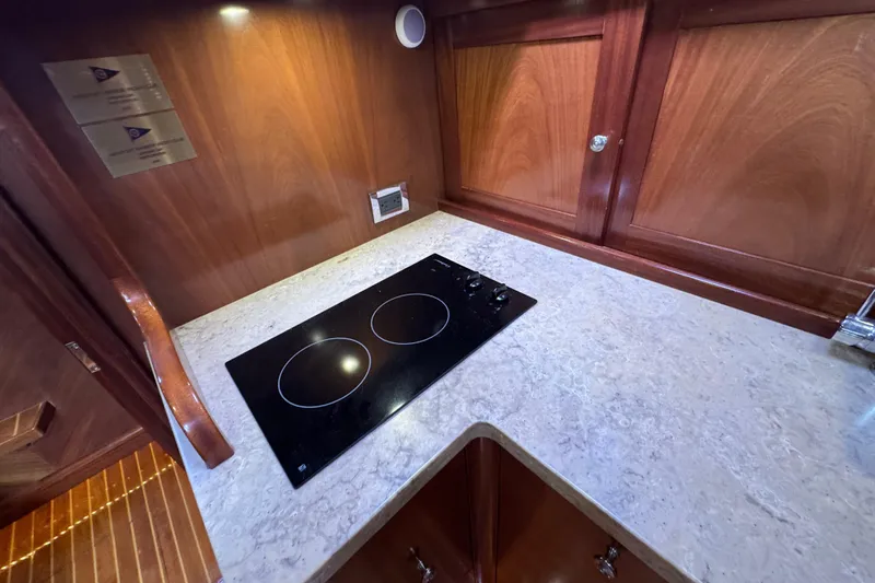 Mango Tango Yacht Photos Pics Luxury yacht kitchen with sleek cooktop, wooden cabinetry, and elegant countertop, San Juan 41, 2014.