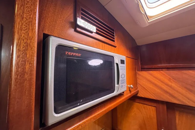 Mango Tango Yacht Photos Pics Microwave in 2014 San Juan 41 yacht interior with wooden cabinetry.