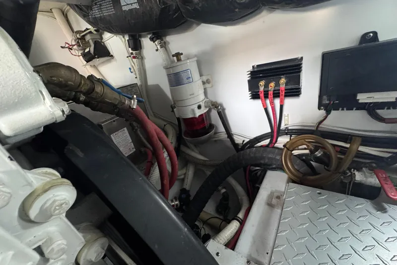 Mango Tango Yacht Photos Pics Engine room of a 2014 San Juan 41 boat, featuring cables and mechanical components.