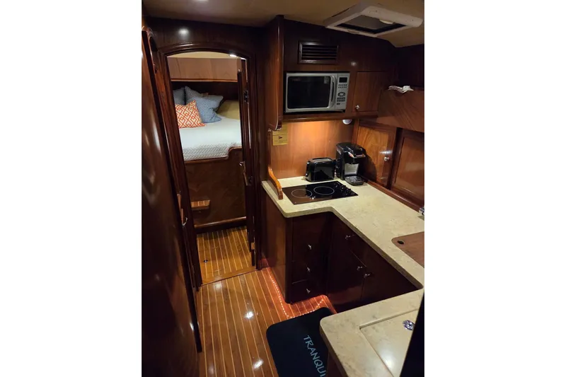 Mango Tango Yacht Photos Pics Luxurious interior of 2014 San Juan 41 yacht with modern kitchen and cozy bedroom.