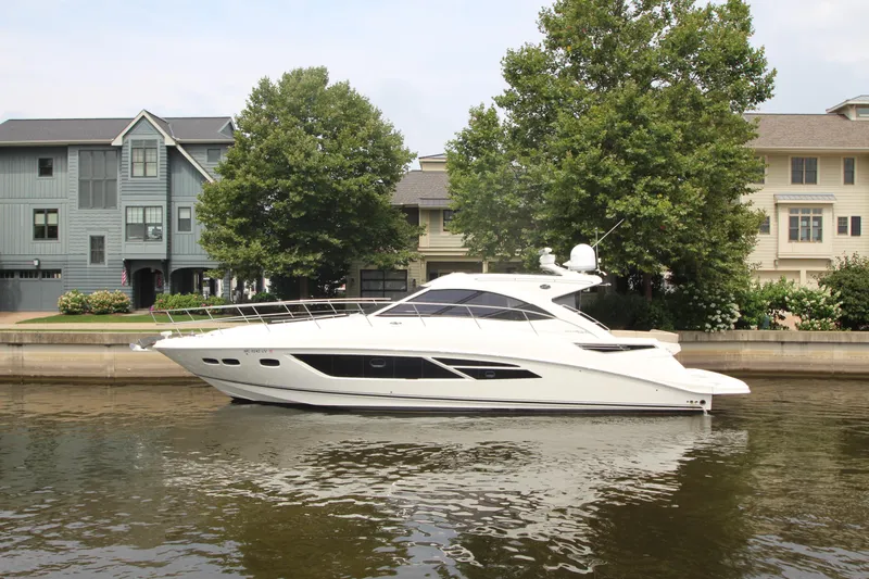  Yacht Photos Pics 2016 Sea Ray 510 Sundancer yacht docked by waterfront homes, surrounded by trees.
