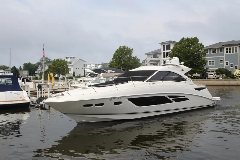  Yacht Photos Pics 2016 Sea Ray 510 Sundancer yacht docked in a marina, surrounded by waterfront homes.