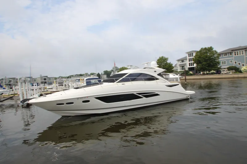  Yacht Photos Pics 2016 Sea Ray 510 Sundancer yacht docked in a marina with waterfront homes.