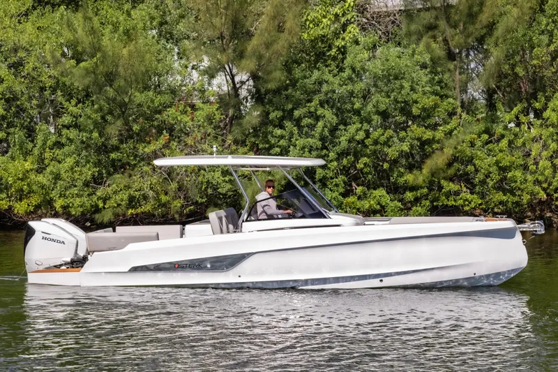  Yacht Photos Pics 2025 STERK 31 boat cruising on a calm river with lush greenery background.