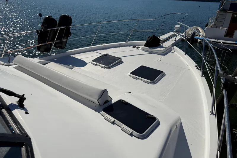 Sea Wolf Yacht Photos Pics 1994 Bayliner 4788 Pilot House Motoryacht deck with hatches, docked on calm water.