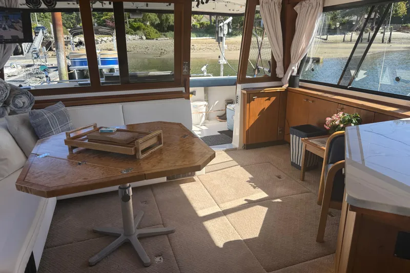 Sea Wolf Yacht Photos Pics Interior of 1994 Bayliner 4788 Pilot House Motoryacht with elegant wood and waterfront view.