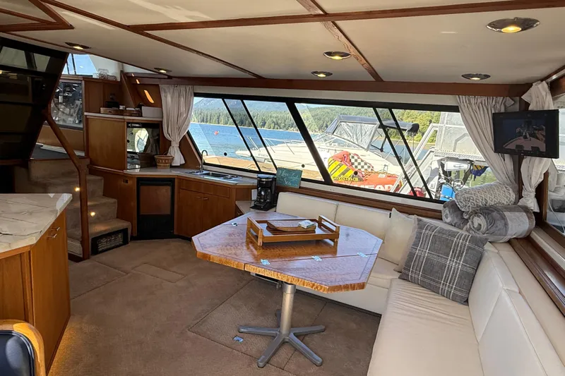 Sea Wolf Yacht Photos Pics Luxurious interior of 1994 Bayliner 4788 Pilot House Motoryacht with scenic marina view.