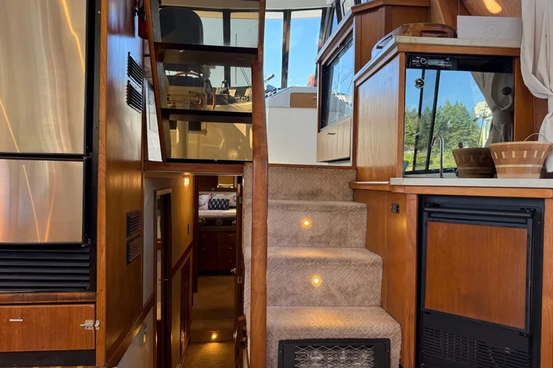 Sea Wolf Yacht Photos Pics Interior of 1994 Bayliner 4788 Pilot House Motoryacht with stairs and kitchenette.