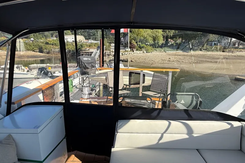 Sea Wolf Yacht Photos Pics 1994 Bayliner 4788 Pilot House Motoryacht interior with marina view and outdoor seating.