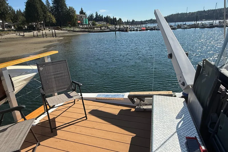 Sea Wolf Yacht Photos Pics Deck view from 1994 Bayliner 4788 Pilot House Motoryacht, overlooking serene marina and shoreline.